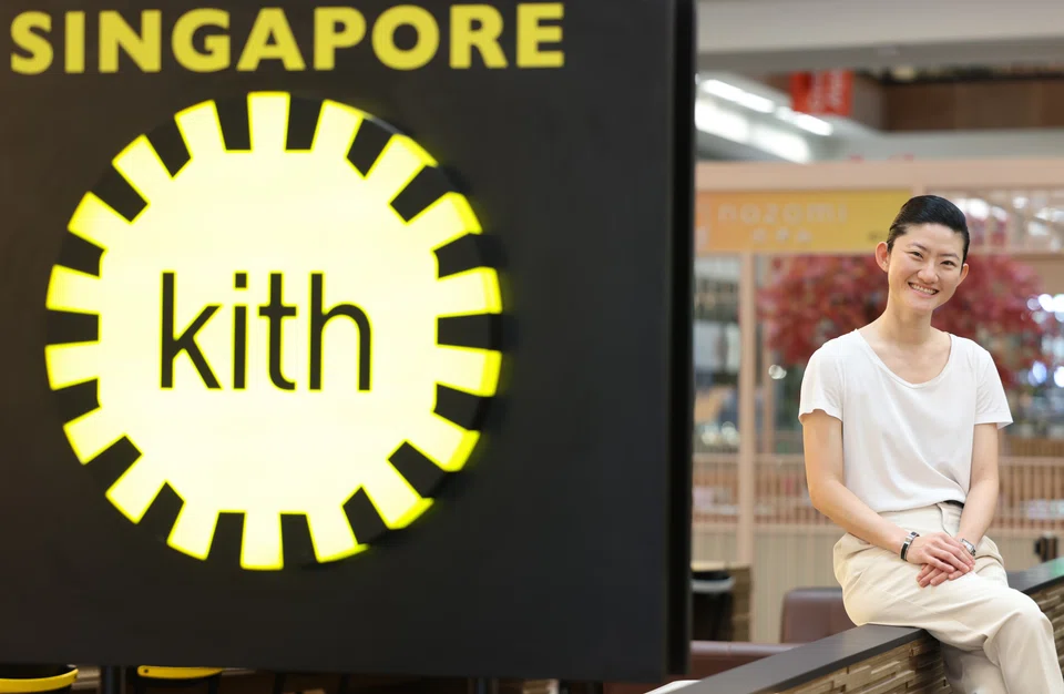 Jane Hia, founder of Kith Cafe, beside the Kith Singapore sign